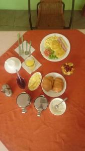 uma mesa com pratos de comida numa mesa vermelha em Grand Hotel Paraiso Insular 1 em Puerto Baquerizo Moreno