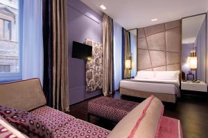 Voodi või voodid majutusasutuse Stendhal Luxury Suites toas