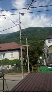 a street light in front of a house with a mountain at Guest House on Abazgaa 30 in Gagra