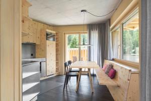 a small kitchen and dining room with a table and chairs at Alpine Lodge Chesa a la Punt in Pontresina