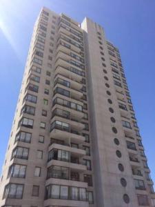 un edificio alto de color blanco con muchas ventanas en Departamento Edificio Boulevard Del Sol 1, en Viña del Mar