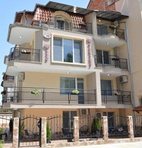 an apartment building with balconies on the side of it at Villa Valentines in Kiten
