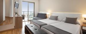 a hotel room with a bed and a chair at RH Bayren Hotel & Spa 4* Sup in Gandía