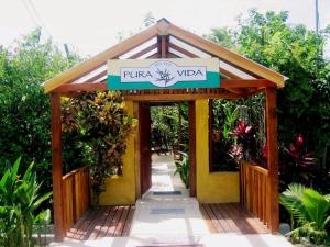 a entrance to a garden with a sign on it at Hotel Pura Vida in Puerto Viejo