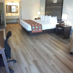 um quarto de hotel com uma cama, uma secretária e uma cadeira em Super 8 by Wyndham Florida City/Homestead/Everglades em Florida City