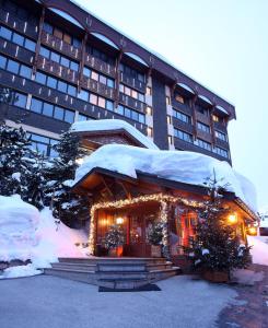 a hotel with christmas lights in front of a building at Alpes Hôtel du Pralong in Courchevel