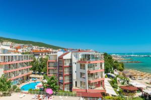 a view of a resort with a pool and the ocean at Iris Beach Hotel in Sveti Vlas