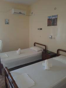 A bed or beds in a room at Pansion Marousa Még 37 kép