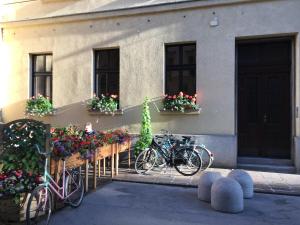 two bikes parked in front of a building with flowers at FORUM Apartment I and II in Ljubljana