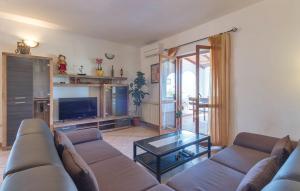 a living room with a couch and a table at Apartments Klaudija in Pula