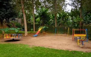 a playground with colorful play equipment in a park at Mvuli Hotels Arusha in Arusha