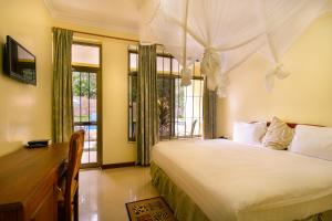 Tempat tidur dalam kamar di Mvuli Hotels Arusha