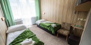 Säng eller sängar i ett rum på Hotel Magura