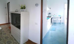 a kitchen with a large white refrigerator and a table at Acquamarina Accommodation in Massa Lubrense