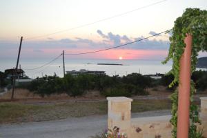 a view of the ocean at sunset from a house at Romantica Apartments in Falasarna