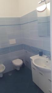 a bathroom with a white toilet and a sink at Acquamarina Accommodation in Massa Lubrense