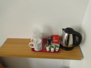 a wooden shelf with a coffee maker and cups on it at Windsor Hotel in Blackpool