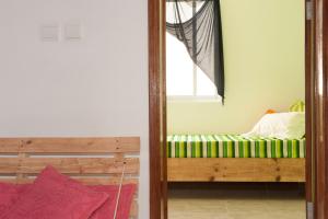 A bed or beds in a room at Simabo's Backpackers' Hostel