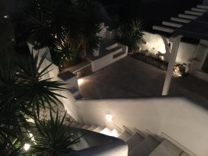 an overhead view of a building with palm trees at night at GKMykonos in Ano Mera