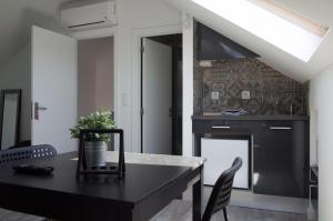a dining room with a black table and a fireplace at Lisbon Beach Apartments 6 in Costa da Caparica