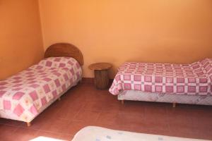 Postel nebo postele na pokoji v ubytování Hostal Coronel Pedro Arraya