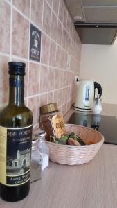 a bottle of wine and a basket of food on a counter at Apartment on Brivzemnieka in Liepāja +1 photo