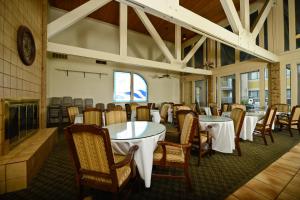 a dining room with tables and chairs and a fireplace at Americas Best Value Inn & Suites Extended Stay - Tulsa in Tulsa