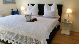 a bedroom with a white bed with a blender on it at ferienhaus-raju-zeltingen in Zeltingen-Rachtig