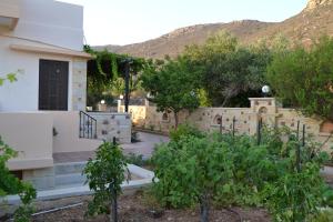 a house with a retaining wall and a garden at Romantica Apartments in Falasarna