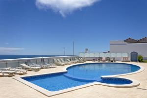 a swimming pool on the roof of a hotel at Oasis Praia Carvoeiro Bay in Carvoeiro