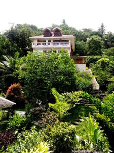 a building in the middle of a garden at Hof Gorei Beach Resort Davao in Samal