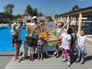 a man and a group of children standing next to a pool at Holiday Park & Resort Niechorze Rewal in Niechorze