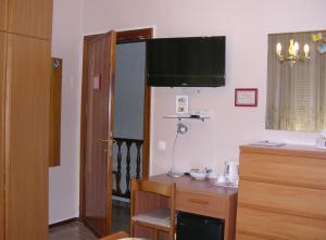 um quarto com uma secretária e uma televisão na parede em A casa di Gianna B&B em Rieti
