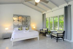 a bedroom with a bed with logs on the wall at Montpelier Plantation & Beach in Nevis