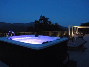 a large jacuzzi tub on a patio at night at Agriturismo Al Pagan in Pigna