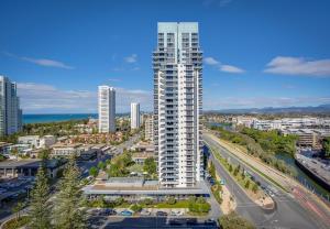 an aerial view of a city with a tall building at Mantra Broadbeach on the Park in Gold Coast