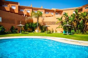 a swimming pool in front of a building at Manilva Beach 140 in Manilva