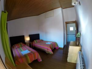 a small room with two beds and a mirror at Casa da Mencha in Vinhais