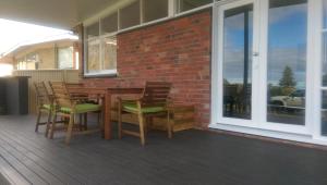 a wooden table and chairs on a patio at My Port Lincoln Place in Port Lincoln