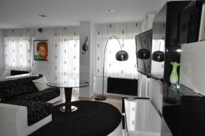 a living room with a couch and a table at Black and White Suitte "Marques" in Noja