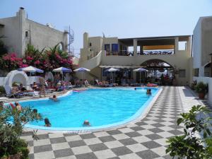 a swimming pool with a pool table and chairs at Levante Beach Hotel in Kamari