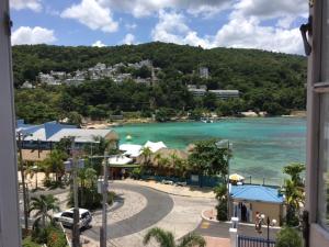 a view of a beach and the ocean from a building at #73 Fisherman's Point in Ocho Rios