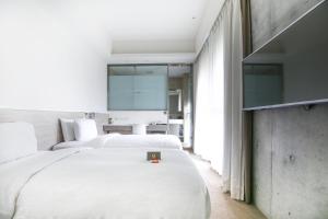 Letto o letti in una camera di CityInn Hotel Plus- Fuxing North Road Branch