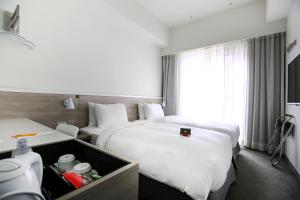 Letto o letti in una camera di CityInn Hotel Plus- Fuxing North Road Branch