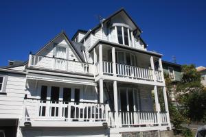 a large white house with a white balcony at The Terrace Villas Serviced Apartments in Wellington