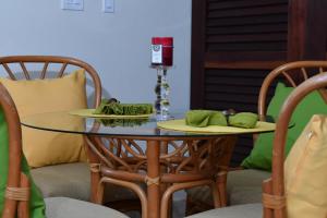 a table with two plates on top of it with chairs at Luxury Beachfront - One Step to Sapphire Beach in East End