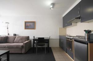 a kitchen and living room with a couch and a table at Arlberg Hotham in Mount Hotham