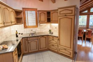 a kitchen with wooden cabinets and a sink at Appartements Zermatt Paradies in Zermatt