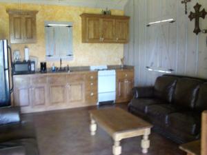 a living room with a couch and a table at Breezy Hills Cottages - Moonlight Cottage in Fredericksburg