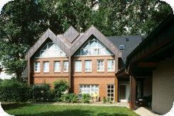 a large brick house with a large window at Haus Mönter-Meyer in Bad Laer